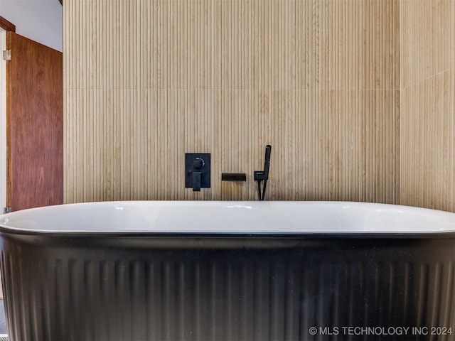 bathroom with a soaking tub and radiator heating unit