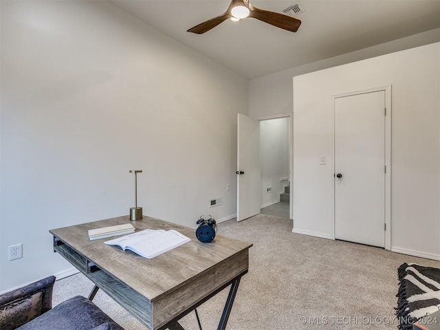 office area featuring light carpet, ceiling fan, visible vents, and baseboards