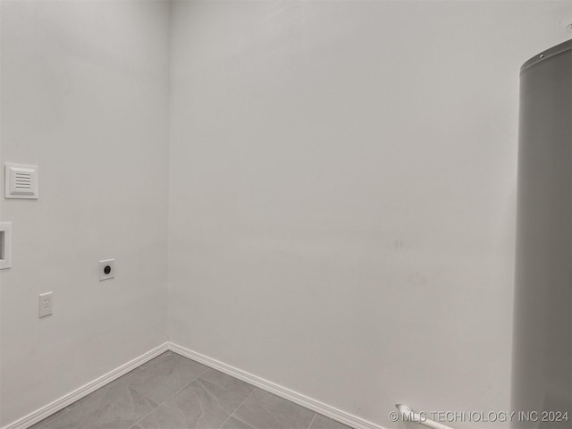 laundry room with baseboards, laundry area, light tile patterned floors, and hookup for an electric dryer