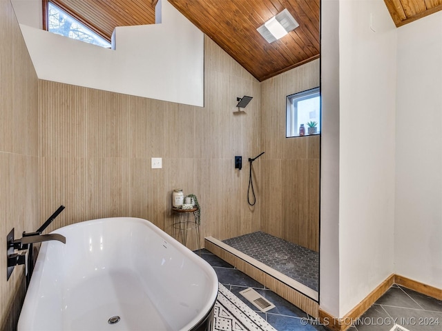 bathroom with vaulted ceiling, tile patterned flooring, walk in shower, and wooden ceiling