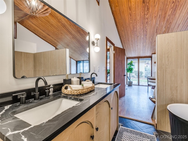 full bathroom with double vanity, a wall of windows, a sink, and wood ceiling