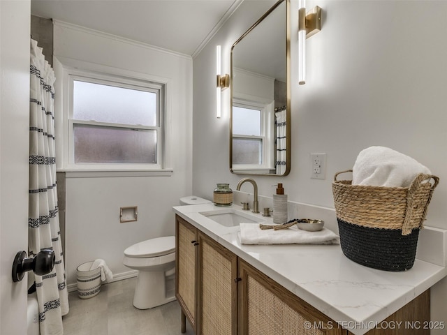 full bath featuring ornamental molding, a healthy amount of sunlight, vanity, and toilet