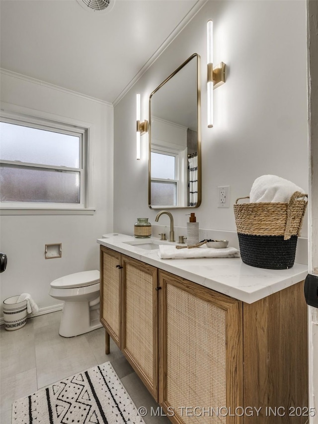 full bath featuring toilet, a healthy amount of sunlight, vanity, and crown molding