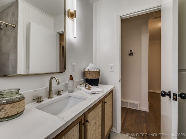 full bathroom with crown molding, visible vents, vanity, wood finished floors, and baseboards