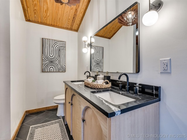 bathroom with toilet, wood ceiling, a sink, and tile patterned floors