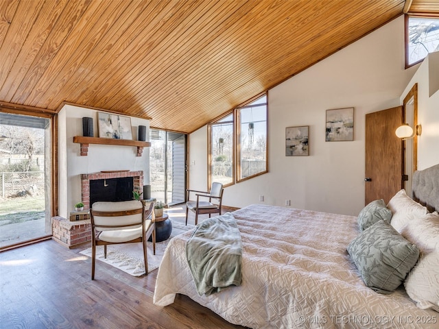 bedroom featuring wood ceiling, access to outside, a fireplace, and wood finished floors