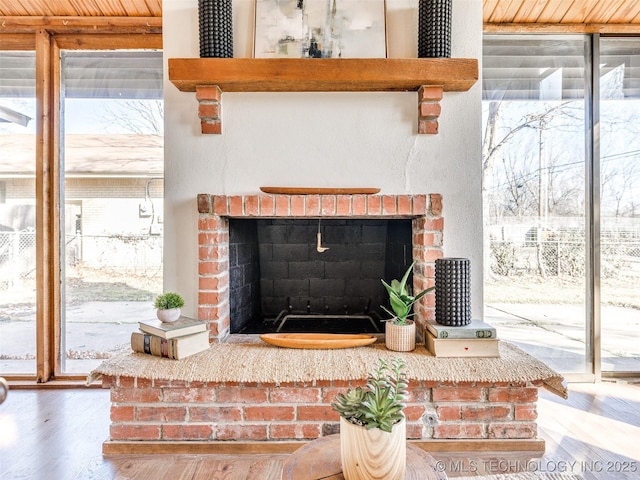 room details featuring a brick fireplace and wood finished floors