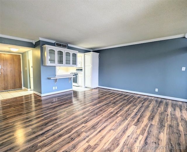 unfurnished living room featuring a textured ceiling, dark hardwood / wood-style floors, and crown molding