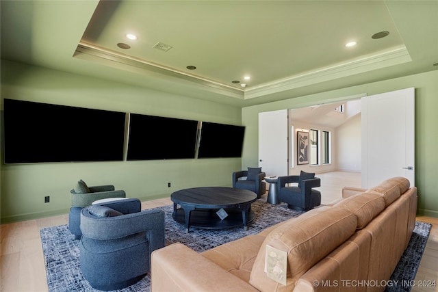 living room featuring a raised ceiling and hardwood / wood-style flooring