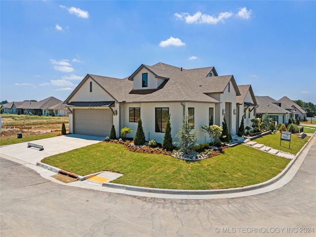 view of front of property with a garage and a front lawn