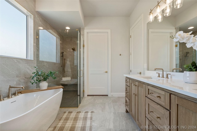 bathroom featuring vanity and independent shower and bath