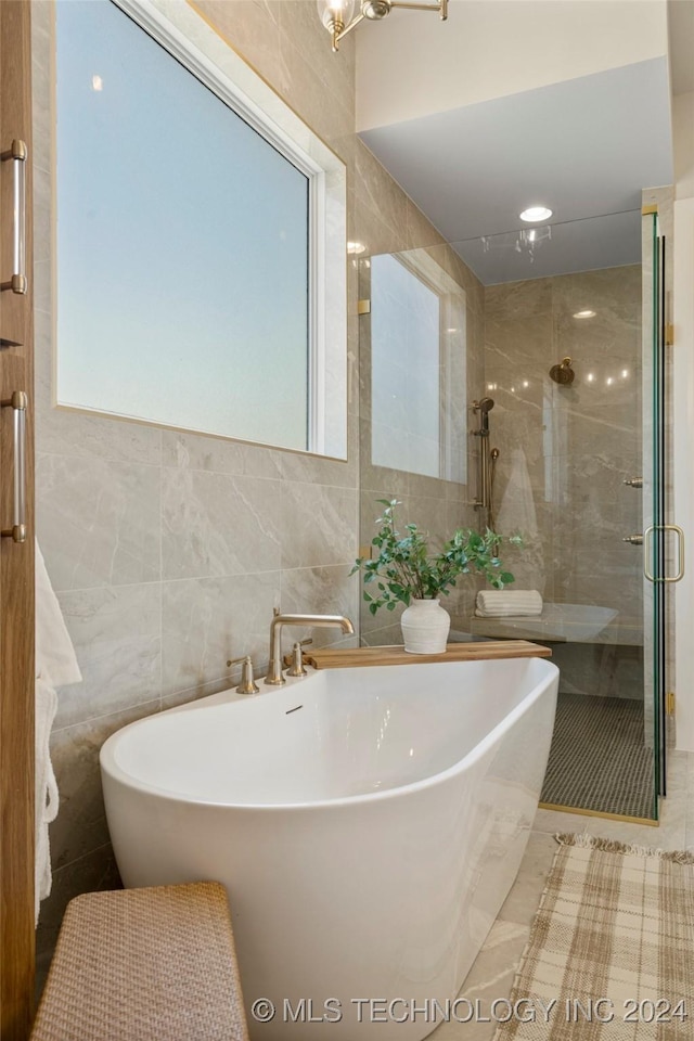 bathroom featuring tile patterned floors, tile walls, and plus walk in shower