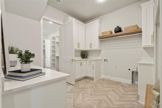 kitchen with white cabinetry and light parquet floors