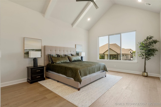 bedroom with ceiling fan, light hardwood / wood-style flooring, high vaulted ceiling, and beamed ceiling