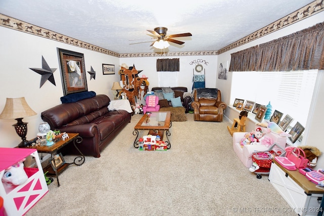 living room featuring ceiling fan, carpet floors, and a textured ceiling