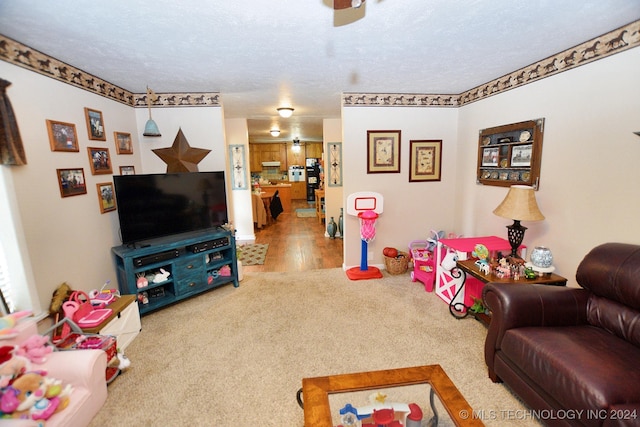 carpeted living room featuring a textured ceiling