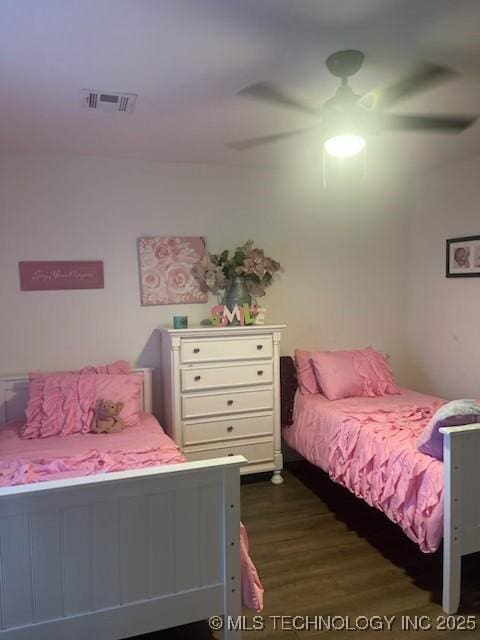 bedroom with ceiling fan and dark wood-type flooring