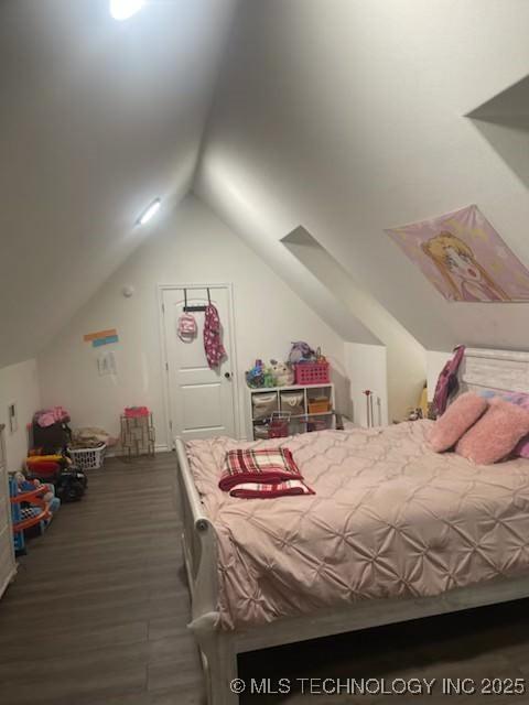 bedroom with dark hardwood / wood-style flooring and vaulted ceiling