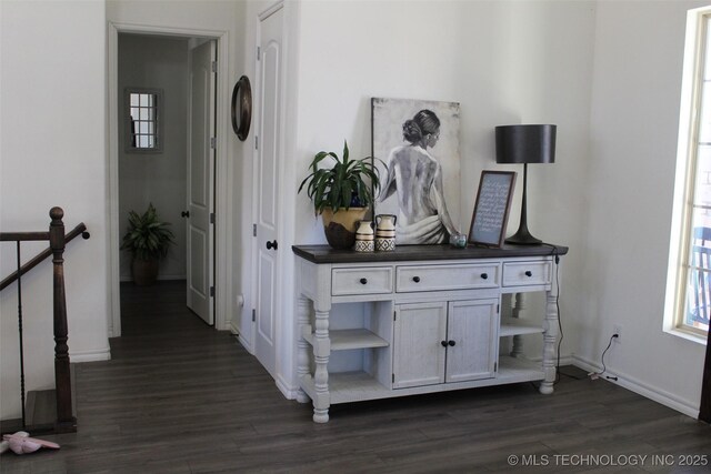 corridor with dark hardwood / wood-style flooring