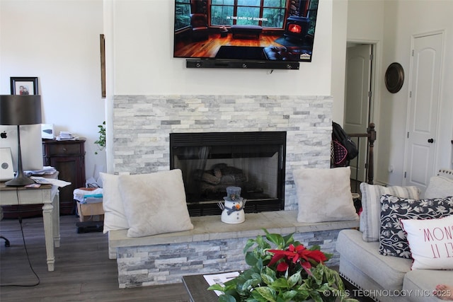 living room with hardwood / wood-style floors and a fireplace