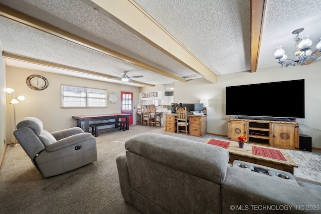 carpeted living room with beam ceiling, ceiling fan with notable chandelier, and a textured ceiling