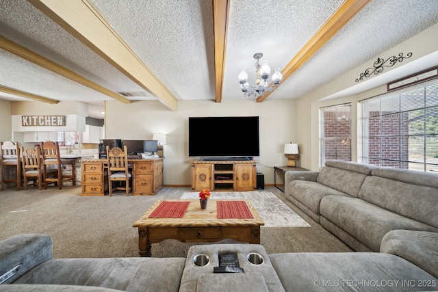 living room featuring beamed ceiling, a textured ceiling, light carpet, and a notable chandelier