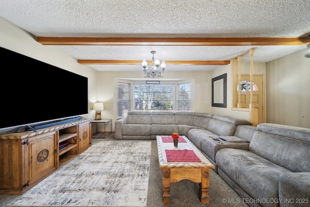 living room with a notable chandelier, beam ceiling, and a textured ceiling