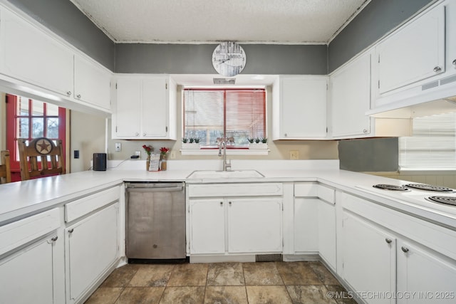 kitchen featuring a healthy amount of sunlight, sink, stainless steel dishwasher, and white cabinets