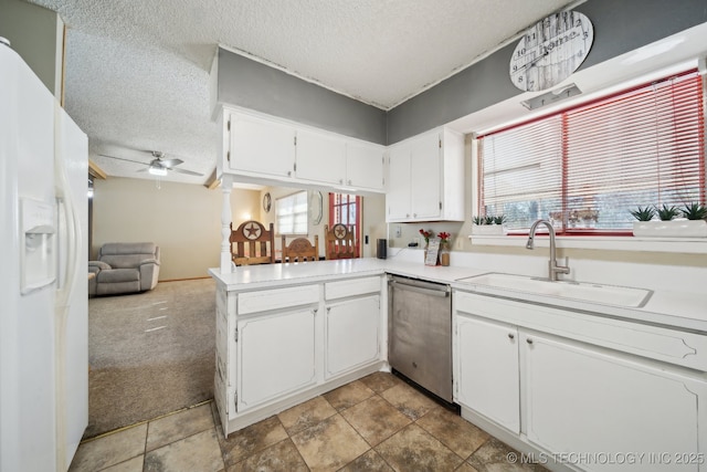 kitchen featuring sink, white fridge with ice dispenser, a textured ceiling, stainless steel dishwasher, and kitchen peninsula