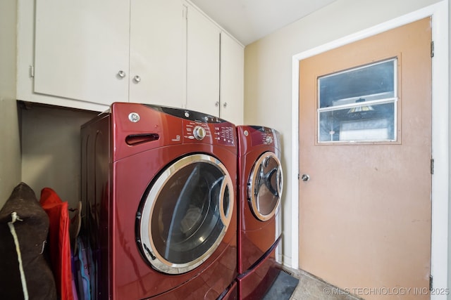 laundry room featuring cabinets and washer and dryer