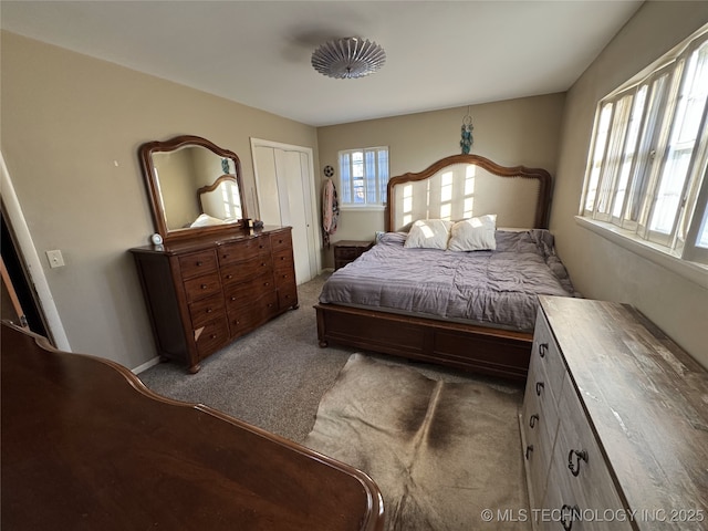 bedroom featuring light carpet and a closet