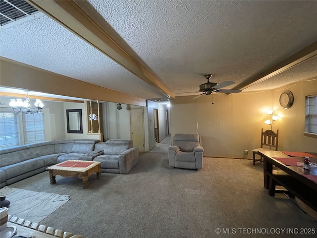 carpeted living room with ceiling fan with notable chandelier and a textured ceiling