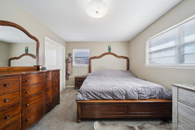 carpeted bedroom with multiple windows