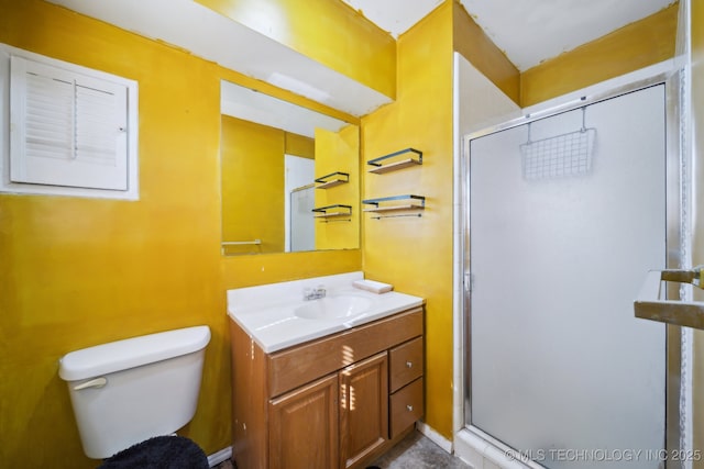 bathroom featuring vanity, an enclosed shower, and toilet