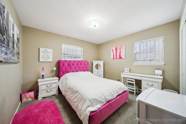 bedroom with dark colored carpet