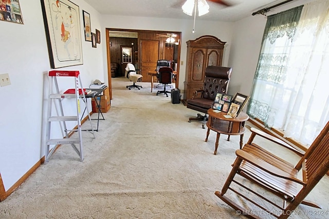 living area with ceiling fan and light carpet