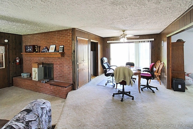 dining space with ceiling fan, wooden walls, and light colored carpet