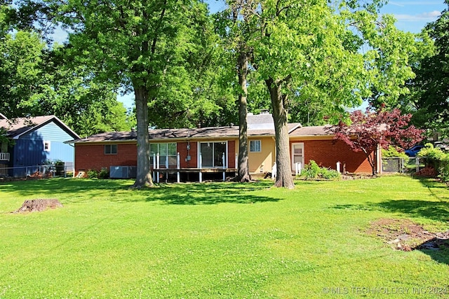 back of property featuring a yard