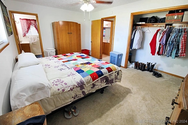 carpeted bedroom with connected bathroom, ceiling fan, a closet, and a textured ceiling