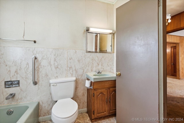 bathroom with vanity, toilet, and a tub to relax in