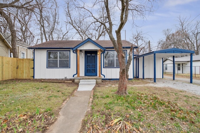 view of front of property featuring a carport and a front lawn