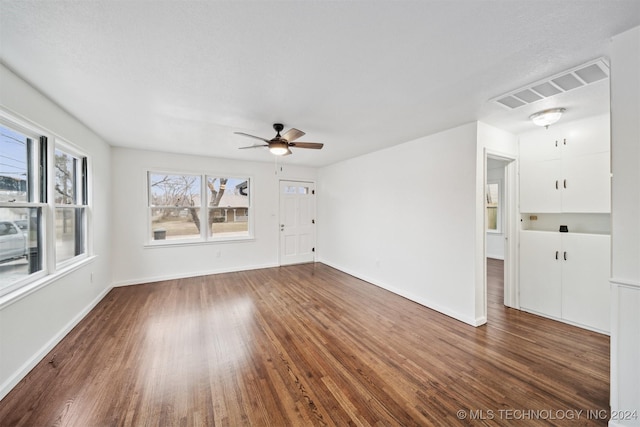 unfurnished room featuring dark hardwood / wood-style floors, a wealth of natural light, and ceiling fan