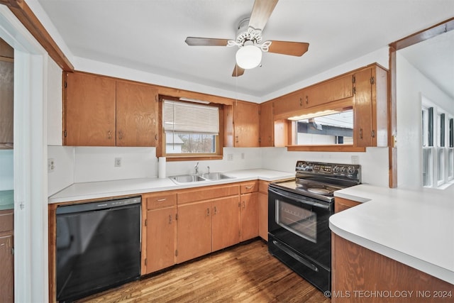 kitchen with black appliances, ceiling fan, light hardwood / wood-style floors, and sink