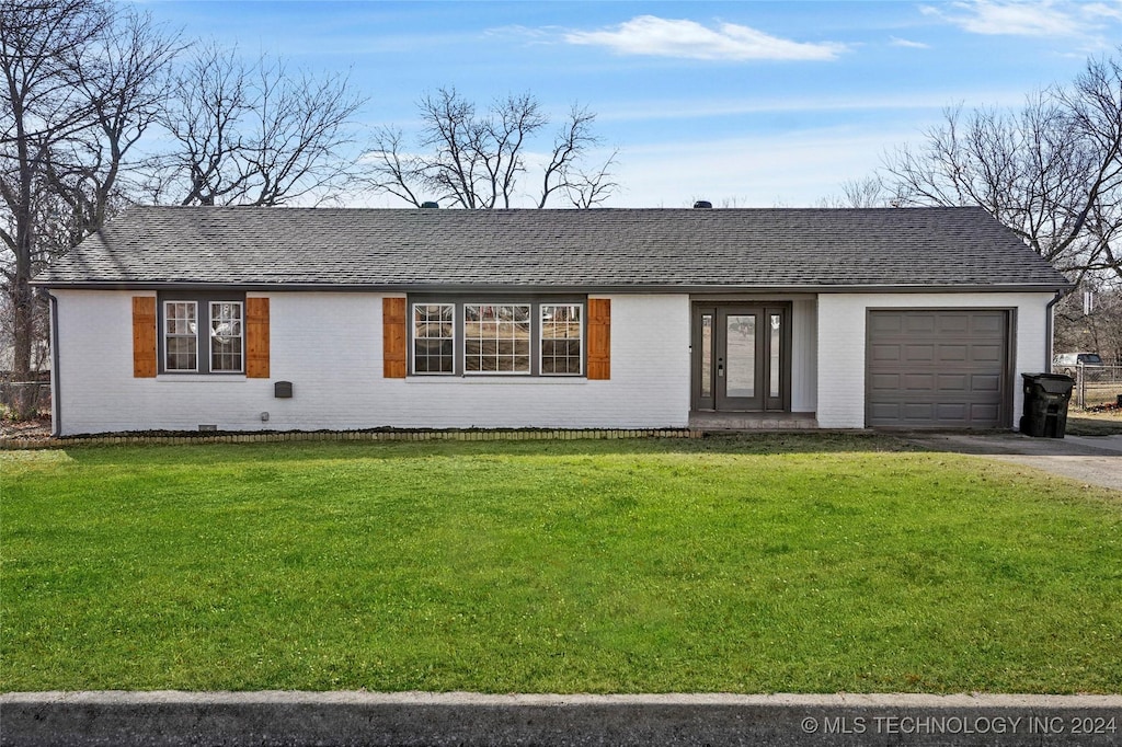 ranch-style house with a front yard and a garage