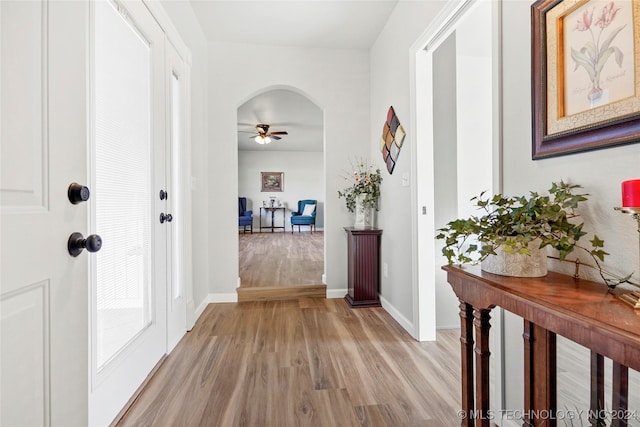 corridor with light hardwood / wood-style floors