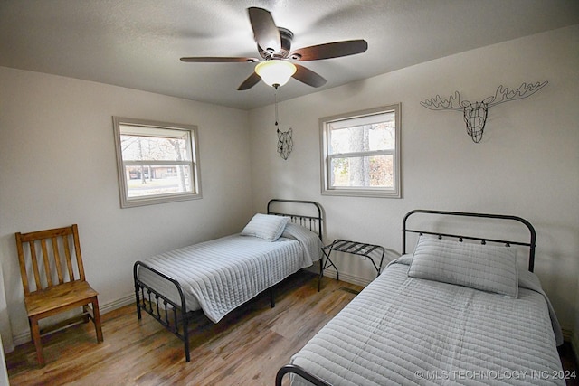 bedroom featuring hardwood / wood-style floors and ceiling fan