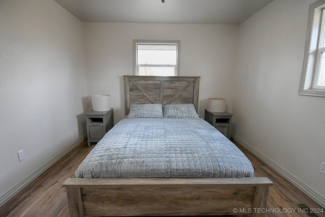 bedroom with hardwood / wood-style flooring