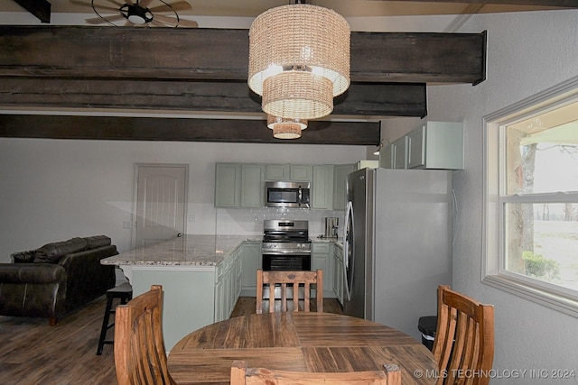 dining space with dark hardwood / wood-style flooring and an inviting chandelier