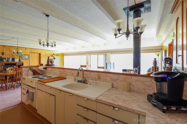 kitchen featuring sink, an inviting chandelier, white range with electric stovetop, decorative light fixtures, and wooden walls