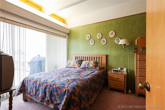 bedroom featuring dark colored carpet, vaulted ceiling, access to outside, and multiple windows